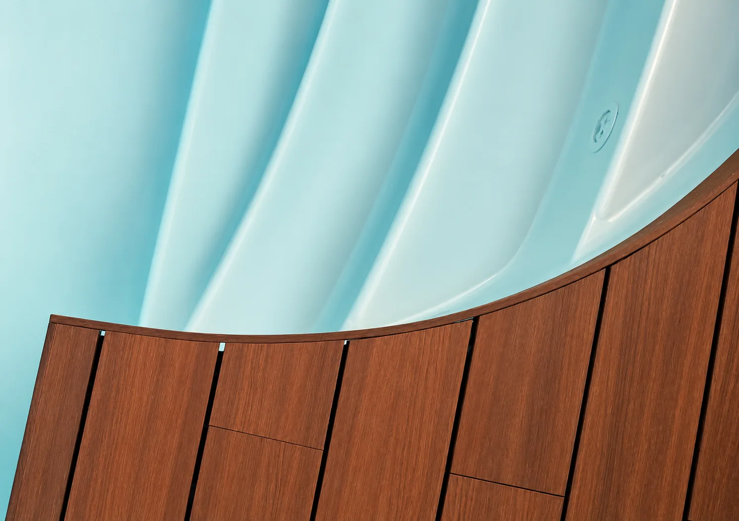 Poolside detail: shaped teak decking following the curve of the pool