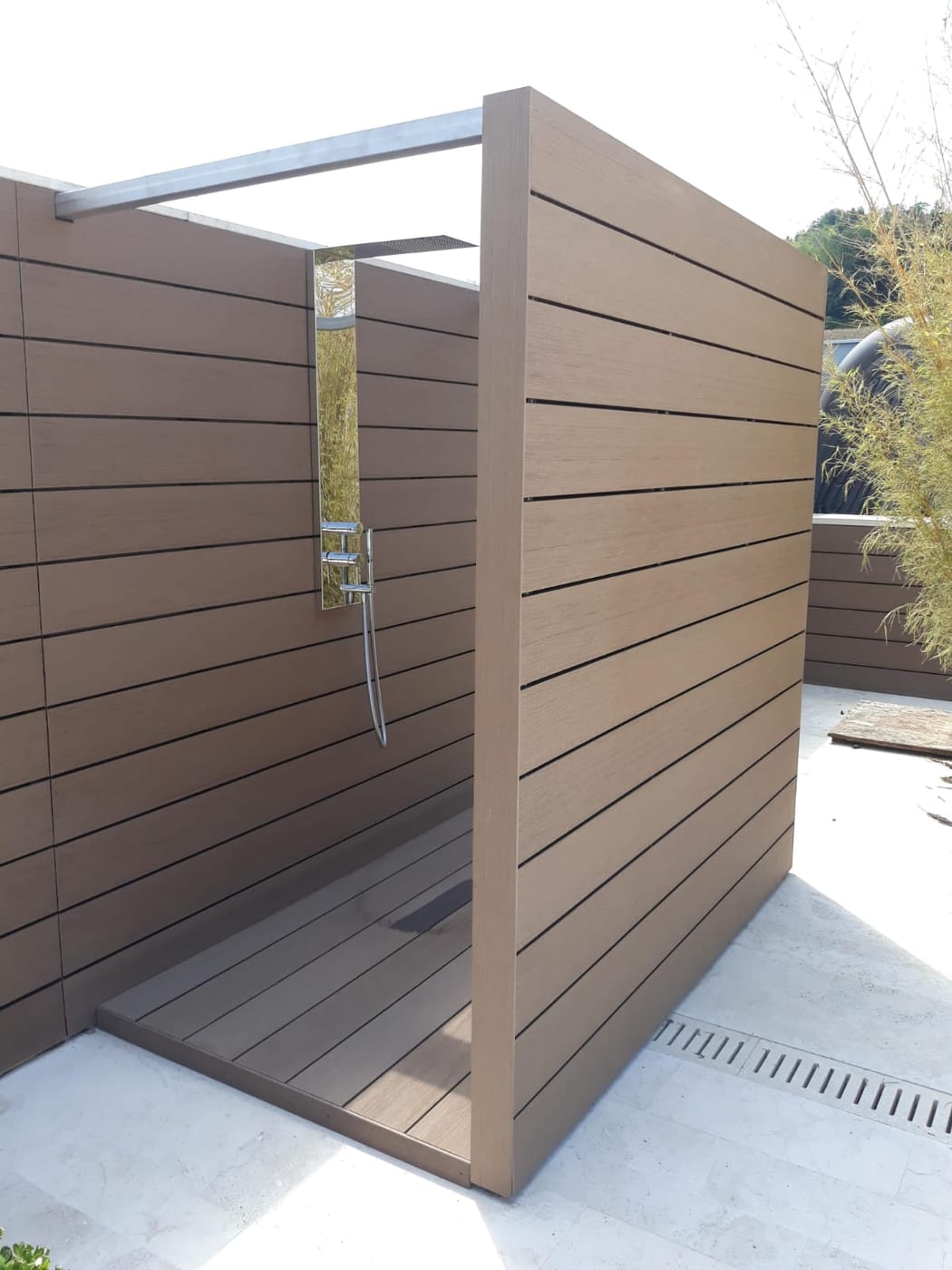 Outdoor shower enclosure clad in WPC
